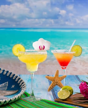 Cocktails Margarita and sex on the beach on blue Caribbean beach with Mexican hat