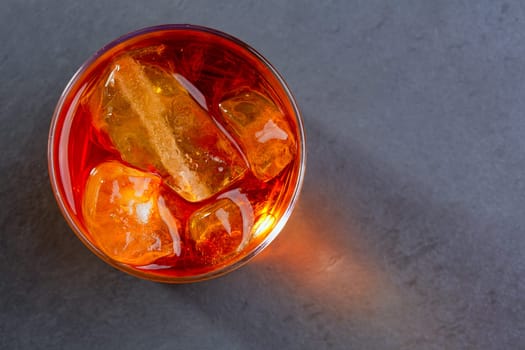Whiskey whisky on the rocks on glass over gray black background