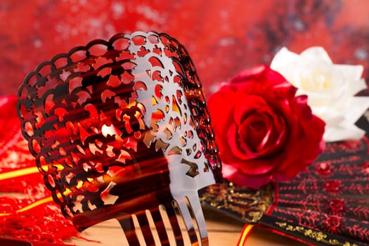 Flamenco comb fan and roses typical from Spain Espana on red background