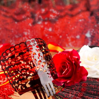 Flamenco comb fan and roses typical from Spain Espana on red background