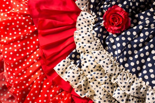 Flamenco dresses in red and blue with spot with red rose typical from Spain Espana