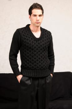 Young man with a Mediterranean look cool wearing casual clothes and posing in front of the camera.