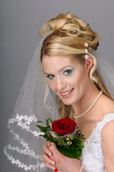 Portrait of a young bride with high hair und white bride dress.