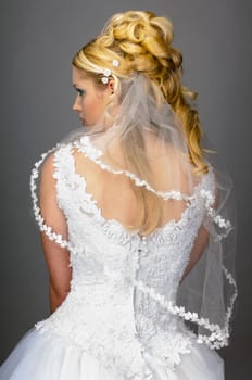 Portrait of a young bride with high hair und white bride dress.