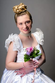 Portrait of a young bride with high hair und white bride dress.