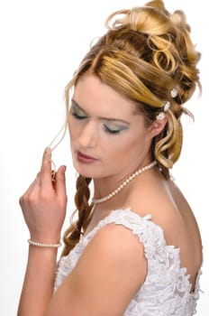 Portrait of a young bride with high hair und white bride dress.