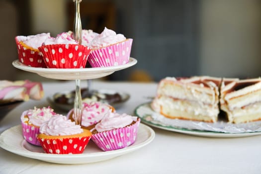 Cupcakes, birthday cake and other sweets on a table