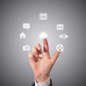 business man touching icons on screen, grey background