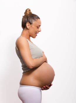 pregnant woman holding and watch her belly