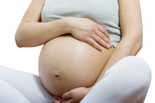 pregnant woman holding her belly in yoga position