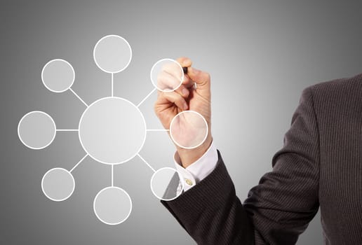Male hand drawing social network structure, grey background