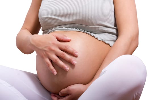 pregnant woman sitting with cross leg and touch her belly