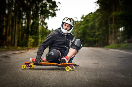 Downhill skateboarder in action on a asphalt road.