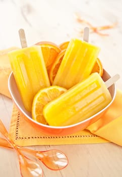 Homemade orange ice popsicles