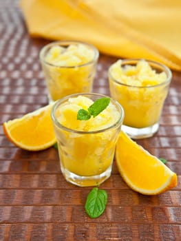 Three small glasses with orange granita / sorbet