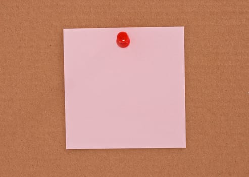 Pink note paper attached with red pin