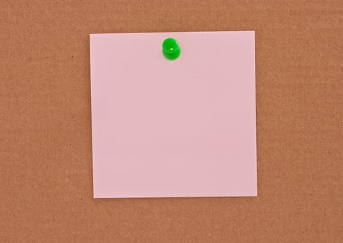 Pink note paper attached with green pin