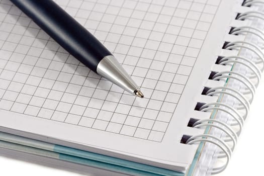 Blue pen with notebook closeup