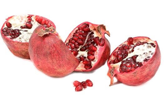 Halved pomegranates isolated on white background