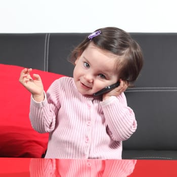 Portrait of a casual baby on the phone at home