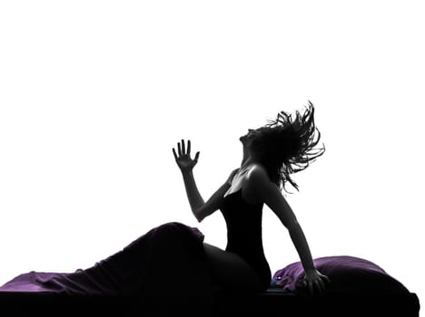 one woman happy awekening sitting in bed in bed silhouette studio on white background
