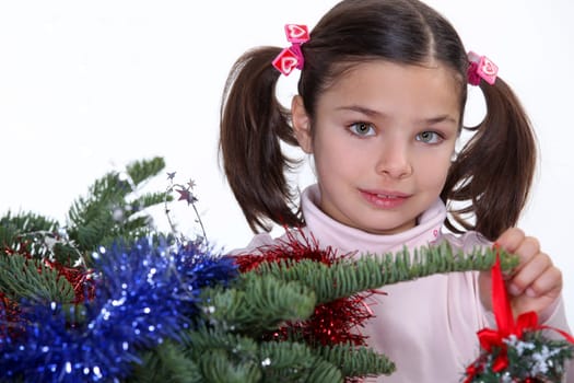 Young girl decorating a Christmas tree