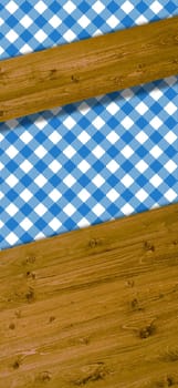 Wooden boards as text background with tablecloth in white and blue
