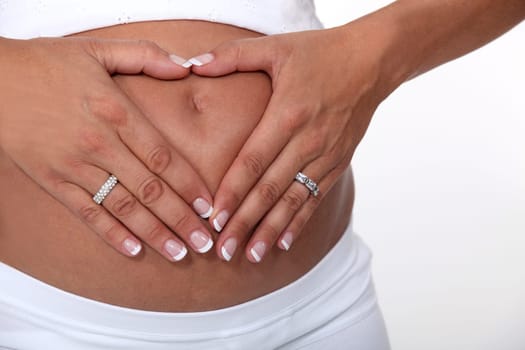 Woman touching her pregnant belly