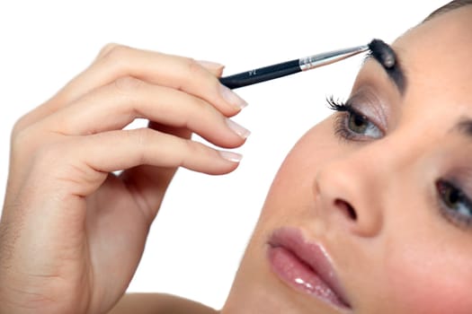 Woman applying make-up