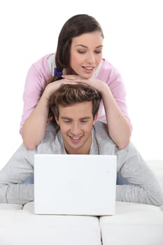 Affectionate couple using laptop together