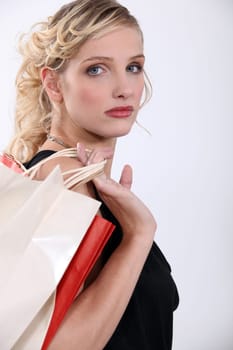 Glamorous woman with store bags