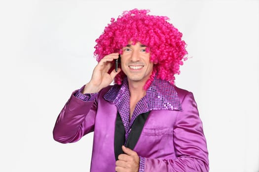 Man in a seventies disco costume and silly wig