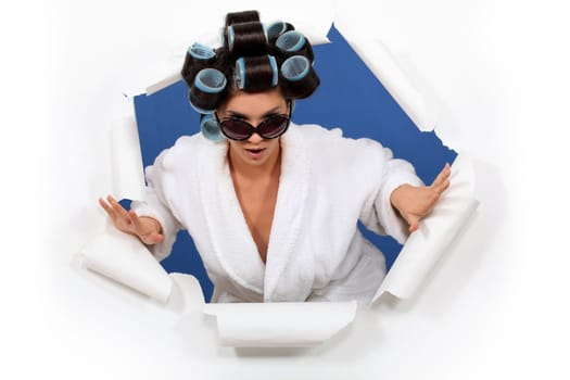 Woman in a bathrobe with her hair in rollers