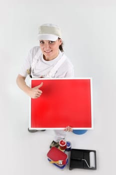Painter pointing to a blank red sign