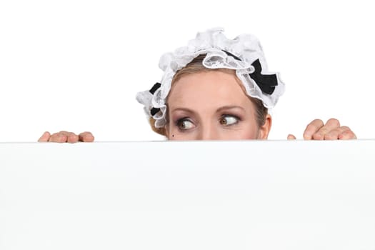 woman hiding behind a board