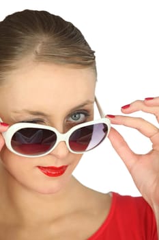 elegant woman looking over her sunglasses