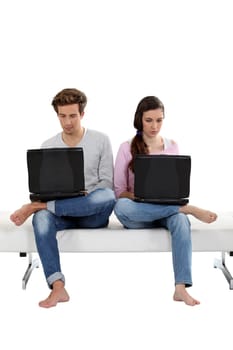 Young couple working on their laptops