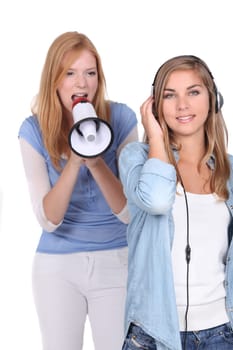 girl listening music while he friends is singing through a megaphone