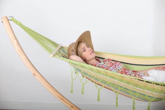 Woman lying relaxing in hammock