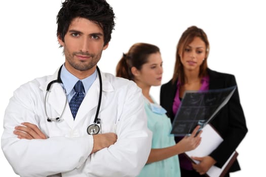 Doctor with medical staff in the background