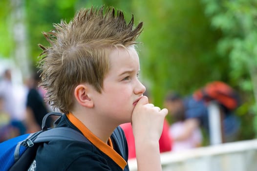 boy with stylish hair is reflecting