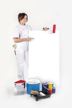 craftswoman painter pointing at an ad board