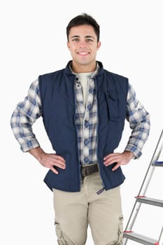 proud tiler posing near ladder and tools