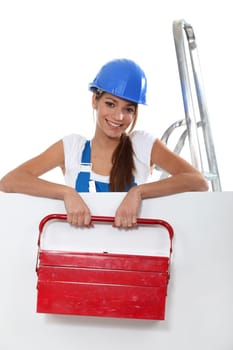 Young woman with a large toolbox and a board left blank for your image