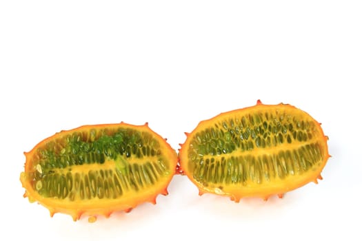 Cucumber (Cucumis metuliferus) in longitudinal section,exposed against a white background