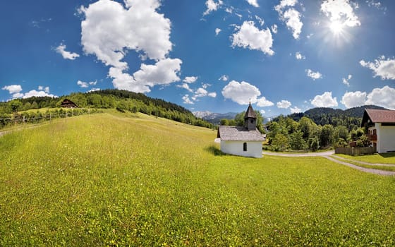 Small chapel at the Graseck with hikers and white-blue sky,Graseck,Garmisch-Partenkirchen,Bavaria,Germany,Europe