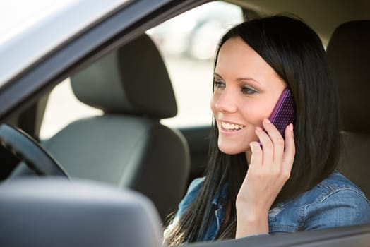 Young beautiful woman calling phone while driving car