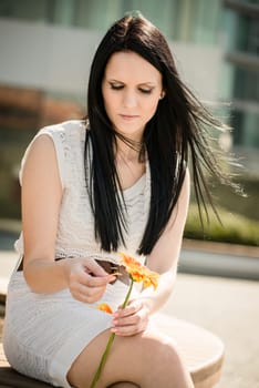 He loves me, he loves me not game - Woman with flower