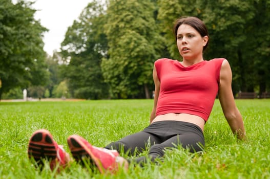 Relax in grass - tired woman after sport