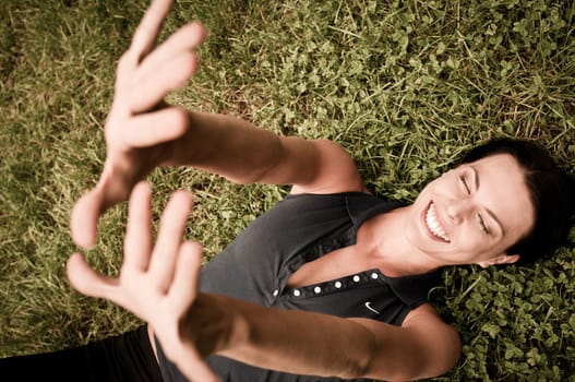 Happiness - woman lying in grass